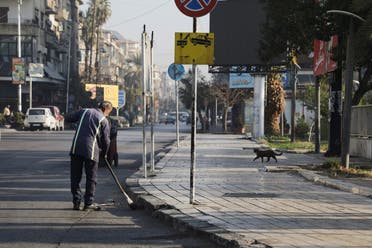 A man cleans the street after Syrian armed opposition forces seized the capital and announced that they had ousted President Bashar al-Assad, in Damascus, Syria, December 9, 2024. (Reuters)