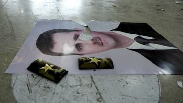 A damaged picture of Syria’s Bashar al-Assad lies on the floor inside Qamishli international airport, after Syrian rebels announced that they have ousted Syria’s Bashar al-Assad, in Qamishli, Syria December 9, 2024. REUTERS/Orhan Qereman