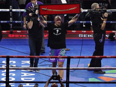 Oleksandr Usyk celebrates after winning the Heavyweight World Title. (Reuters)