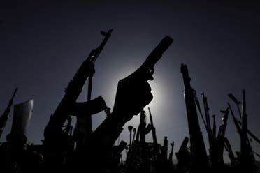 Protesters, mainly Houthi supporters, raise their weapons during a rally to show support to Palestinians in the Gaza Strip, in Sanaa, Yemen December 27, 2024. (Reuters)