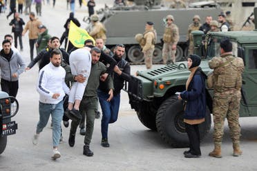 Man carries an injured person in Burj al-Muluk, near the southern Lebanese village of Kfar Kila, where Israeli forces remained on the ground after a deadline for their withdrawal passed as residents sought to return to homes in the border area, Lebanon, January 26, 2025. (Reuters)