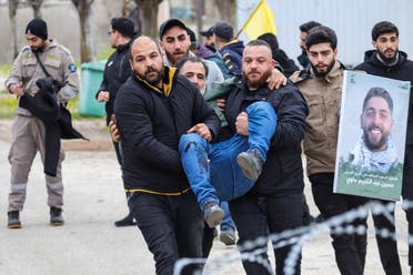 Residents carry a man injured by Israeli fire to safety in Burj al-Muluk, in the outskirts of Kfar Kila, on January 26, 2025. (AFP)