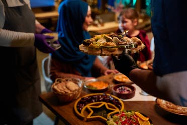 A professional chef serves a family their iftar meal during the holy month of Ramadan. (Envato)