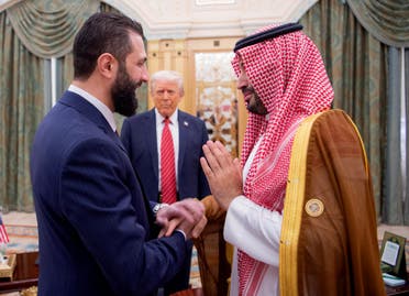 A handout picture provided by the Saudi Royal Palace shows Saudi Crown Prince Mohammed bin Salman (R) greeting Syria's interim president Ahmed al-Sharaa as US President Donald Trump looks on, in Riyadh on May 14, 2025. (AFP)