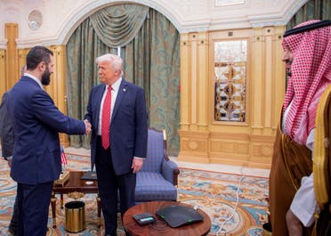 A handout picture provided by the Saudi Royal Palace shows Saudi Crown Prince Mohammed bin Salman (R) watching as US President Donald Trump (C) shakes hands with Syria's interim president Ahmed al-Sharaa in Riyadh on May 14, 2025. (AFP)