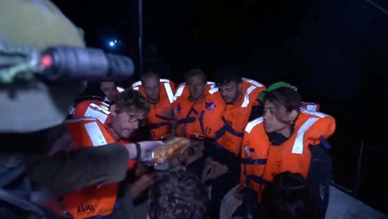 An Israeli solider passes food to those onboard the Gaza-bound British-flagged yacht Madleen after Israeli forces boarded the charity vessel as it attempted to reach the Gaza Strip in defiance of an Israeli naval blockade, in this screengrab from video released on June 9, 2025. Israel Foreign Ministry via X/Handout via REUTERS THIS IMAGE HAS BEEN SUPPLIED BY A THIRD PARTY MANDATORY CREDIT TPX IMAGES OF THE DAY