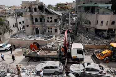A view of a damaged residential buildings and vehicles after impact from missiles fired from Iran, in northern Israel, in Tamra, Israel, June 15, 2025. (Reuters)