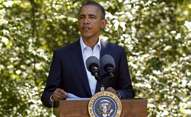 Obama says Qaddafi era over, promises US aid for “democratic” Libya