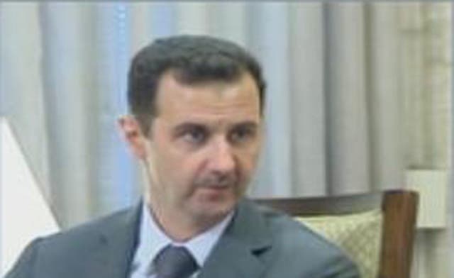 Syrian TV shows images of Assad as battles rage on for control of Damascus